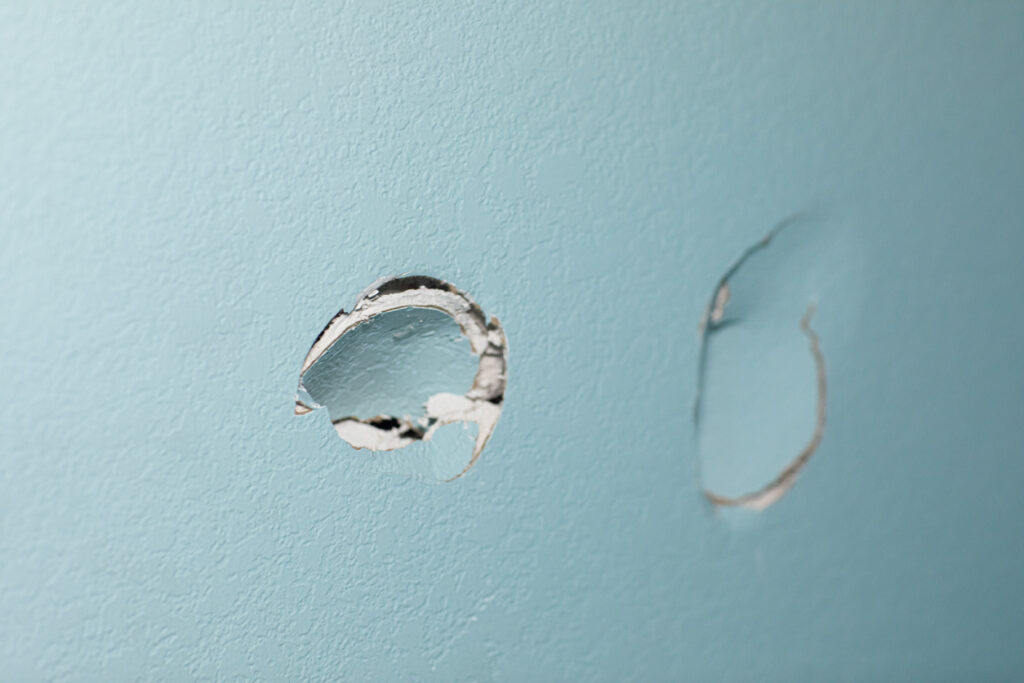 A wall with two dents in it