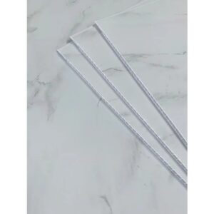 White marble wall panels by DBS bathrooms laid out on the floor.