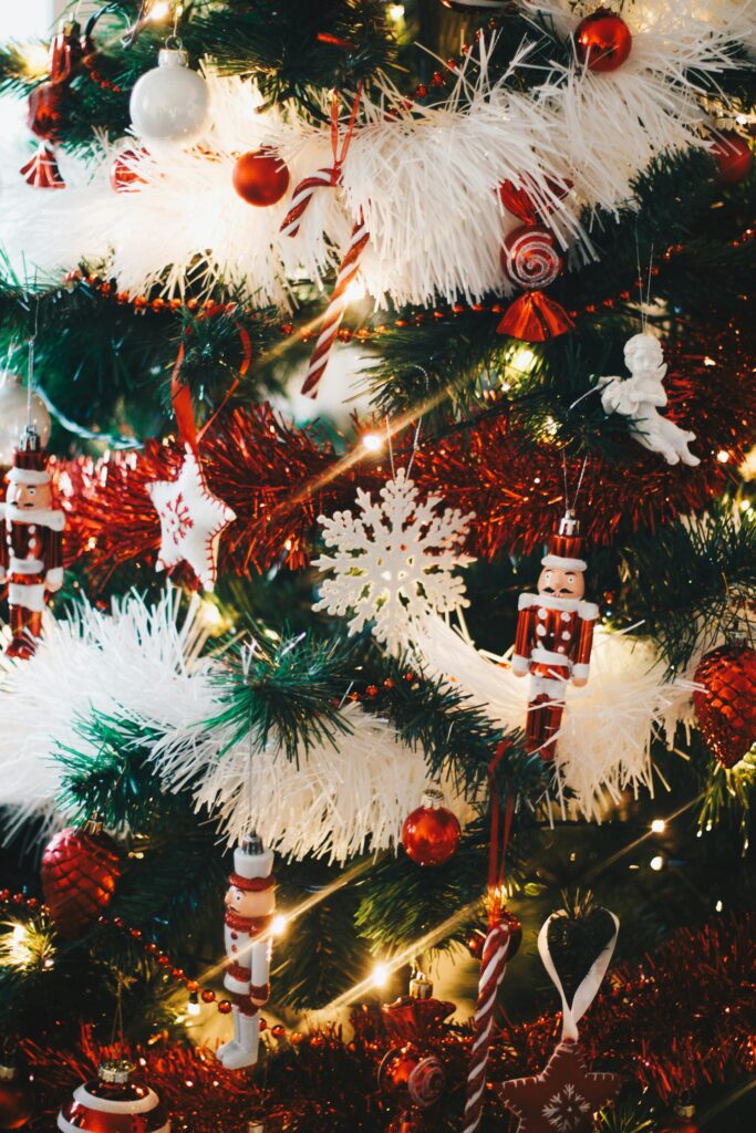 Faux Christmas tree with vintage ornaments and red and white tinsel.