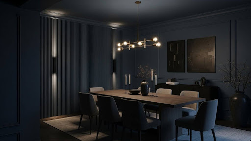 A dark grey colour-drenched dining room with grey slat panelling along one wall, a light grey rug, and a wooden dining table in the centre of the room with eight grey chairs.