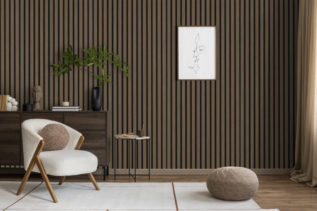 A stylish living room featuring a cream armchair, minimalist mock up line art, and lush green plants. A perfect blend of modern comfort and natural beauty.